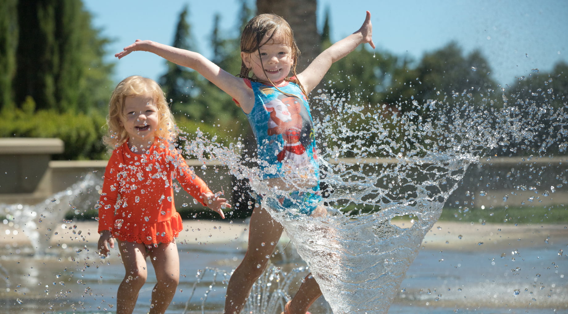 Children splashing water at a park