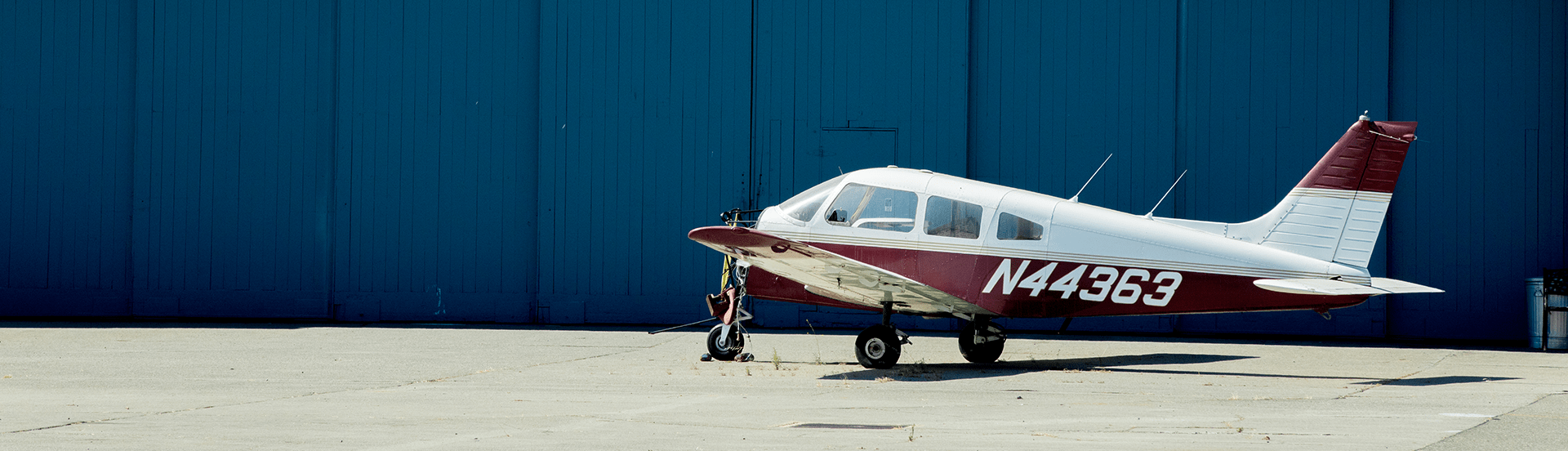 Airplane at rest outside of hangar