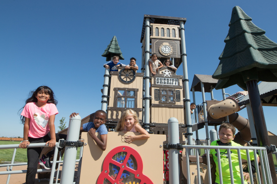 Children pose for photograph at playground